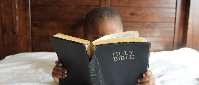 Child reading bible