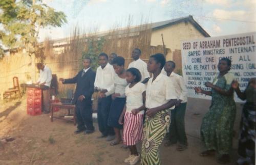 Overseer Khobidi dancing with the Praise Team in an open air revival meeting